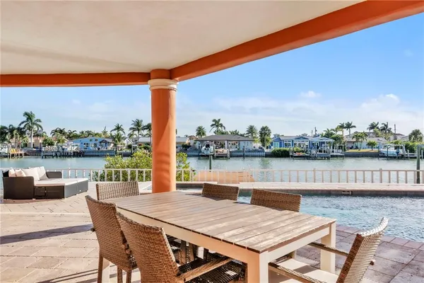 a view of a dining room with furniture a chandelier and wooden floor