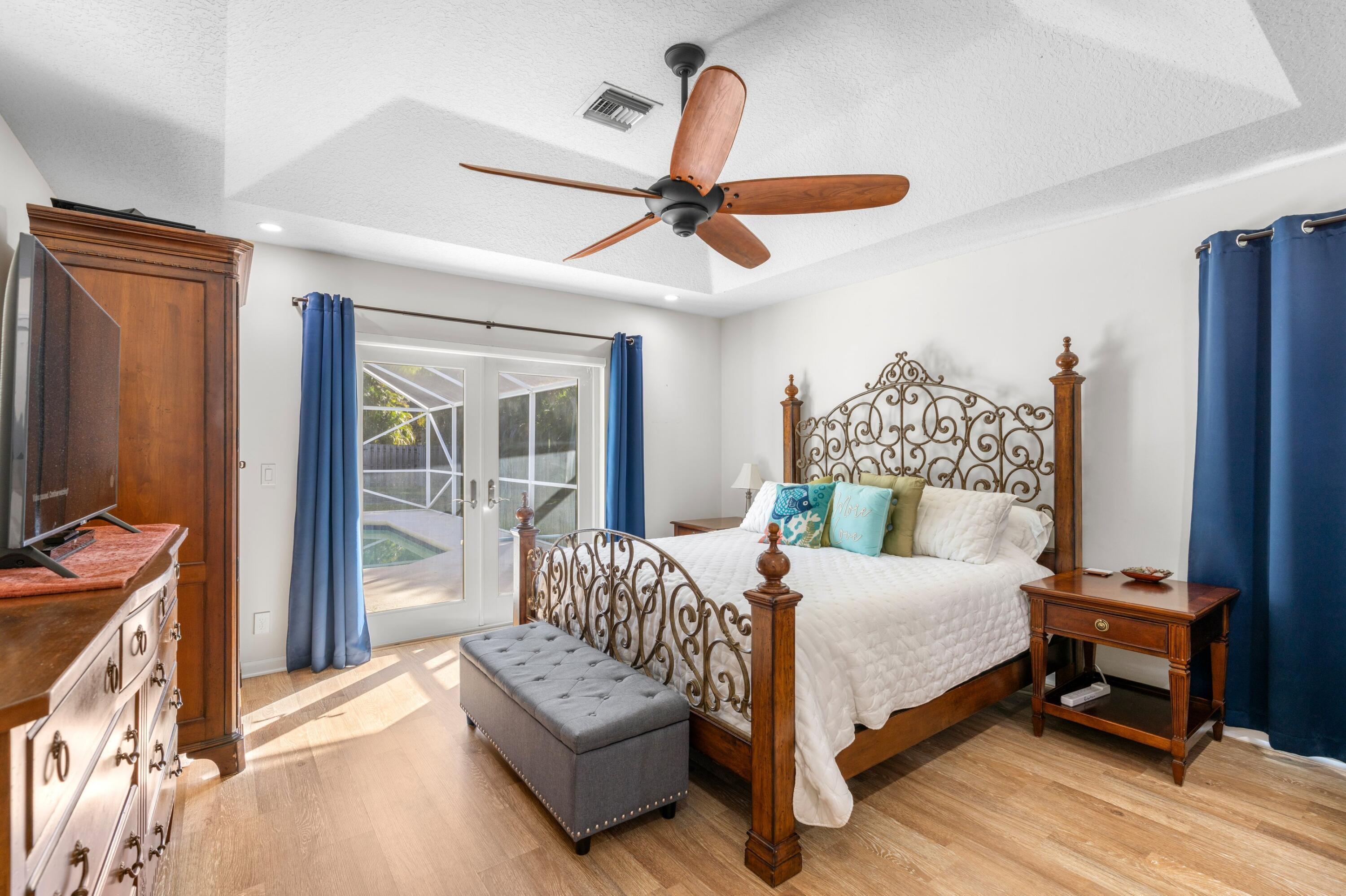 17392 Mellen Lane Jupiter, FL 33478 - Photo 13 of 38 a bedroom with a bed couch and a window