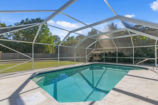 a view of a swimming pool with outdoor space and windows