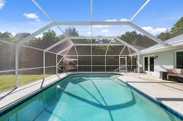 a view of a backyard with a swimming pool