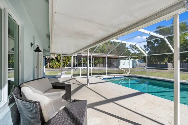 a view of swimming pool with seating area and furniture
