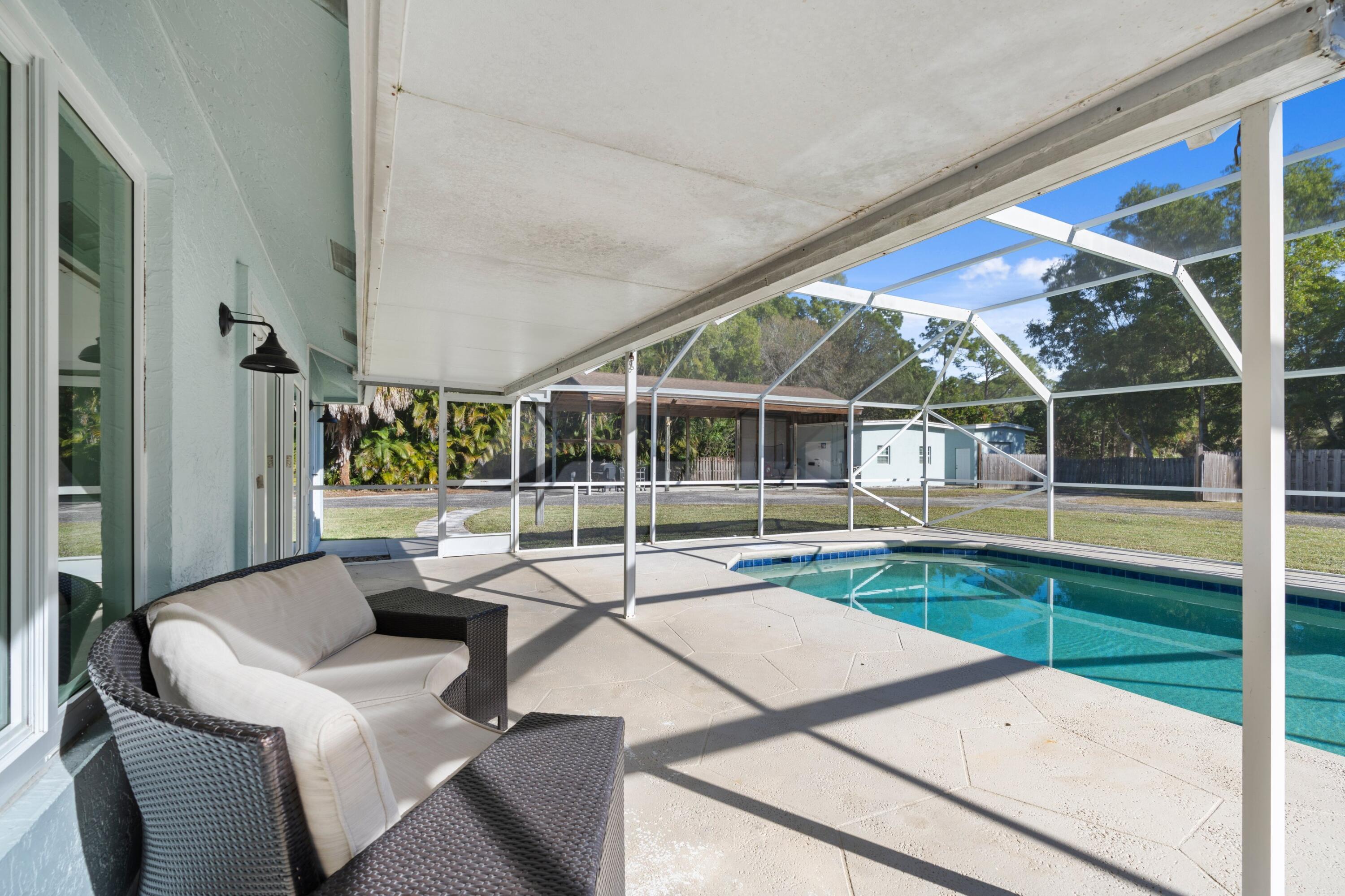 17392 Mellen Lane Jupiter, FL 33478 - Photo 18 of 38 a view of swimming pool with seating area and furniture