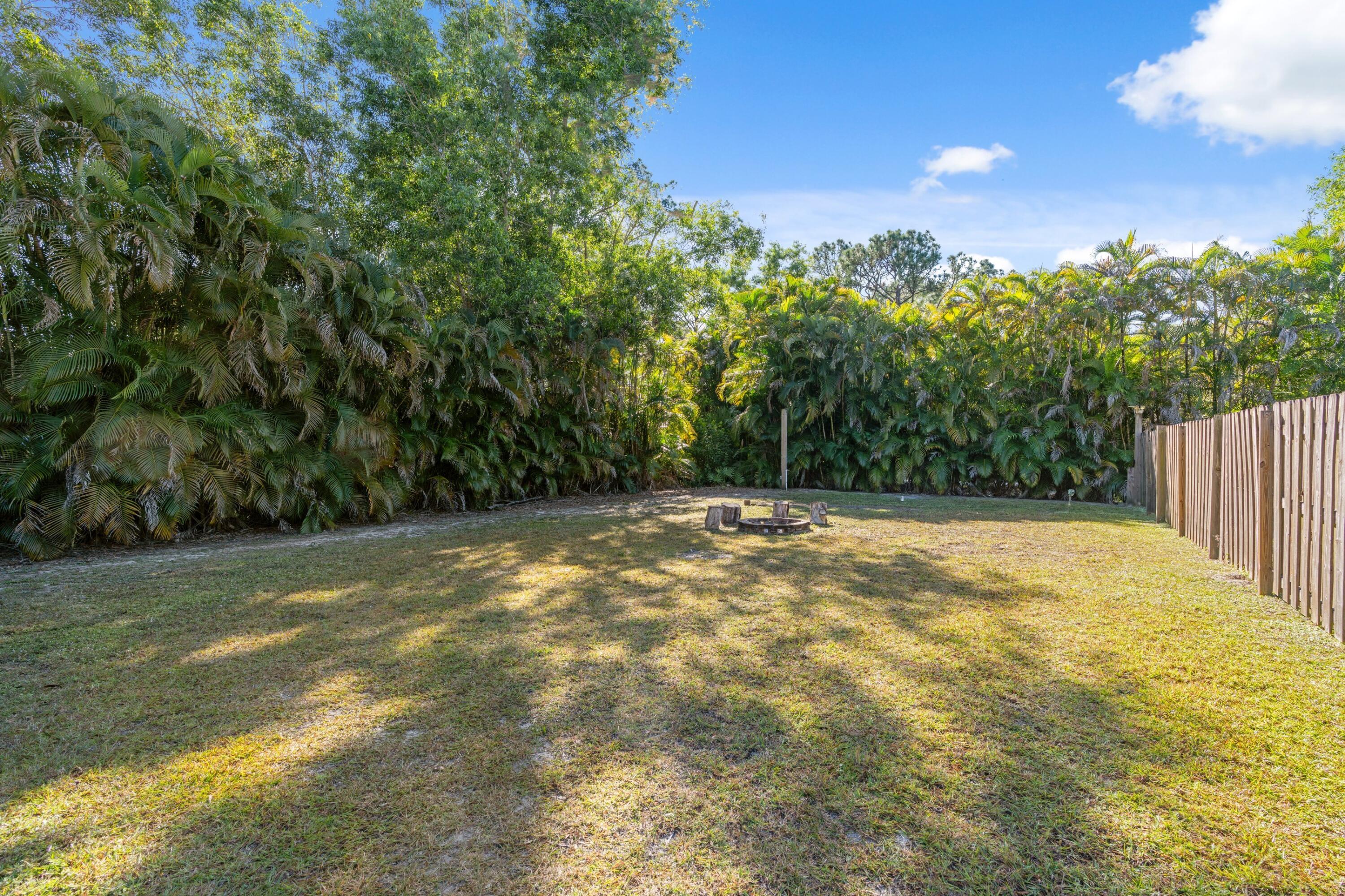 17392 Mellen Lane Jupiter, FL 33478 - Photo 23 of 38 a view of a yard with a trees