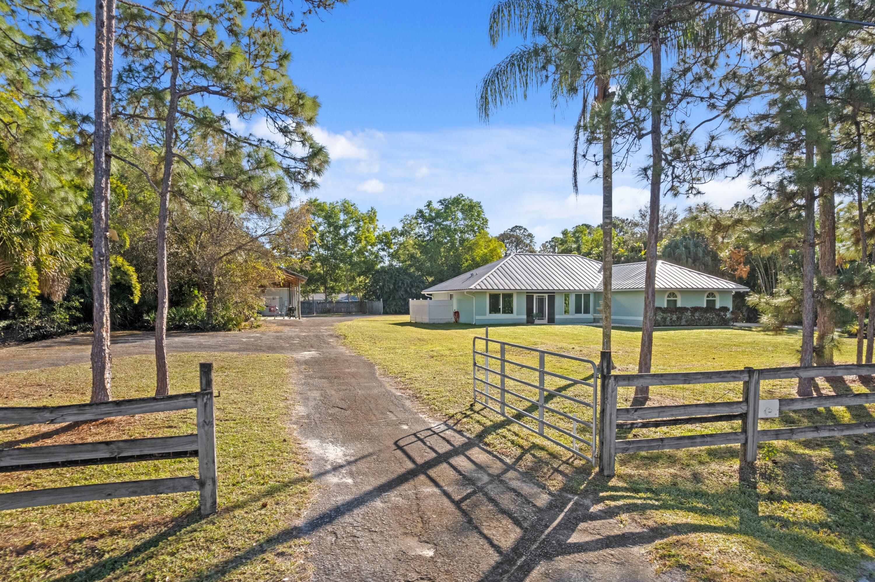 17392 Mellen Lane Jupiter, FL 33478 - Photo 32 of 38 a view of a swimming pool with a patio