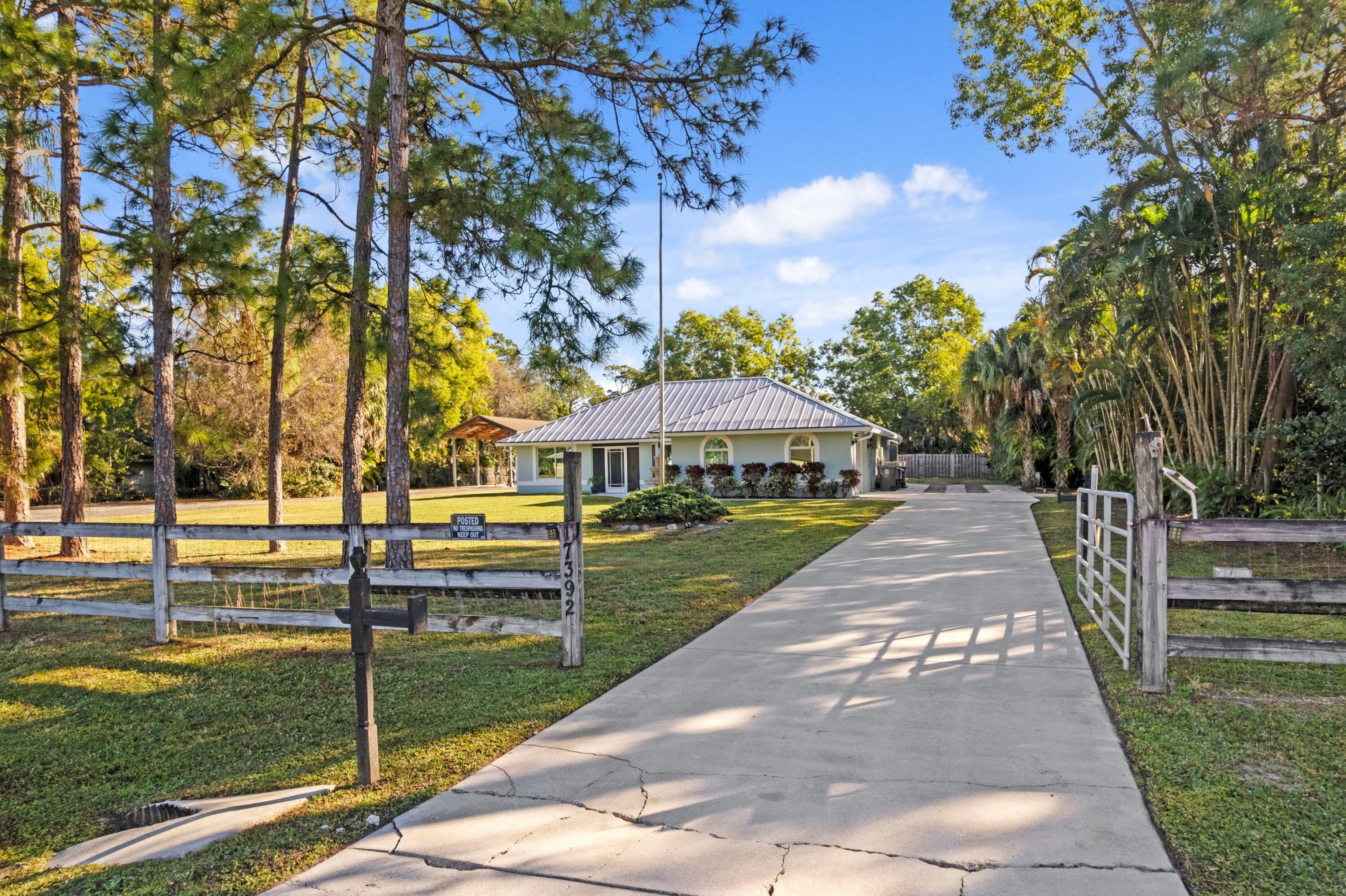 17392 Mellen Lane Jupiter, FL 33478 - Photo 34 of 38 a front view of a house with garden