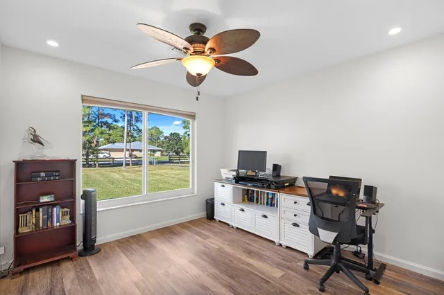 a view of a workspace with furniture and a window