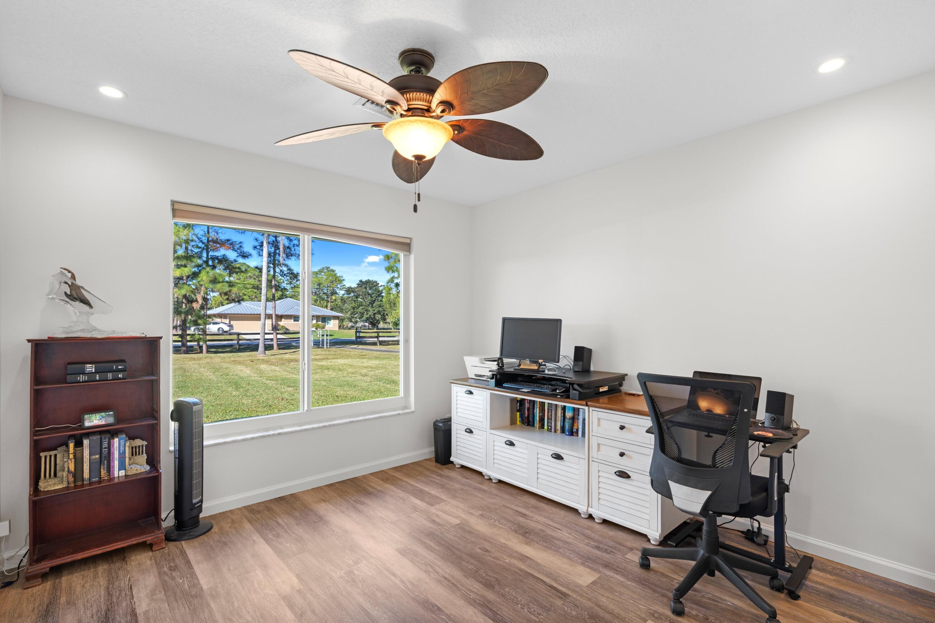 17392 Mellen Lane Jupiter, FL 33478 - Photo 10 of 38 a view of a workspace with furniture and a window