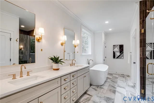 a bathroom with a granite countertop toilet a sink a mirror and a window