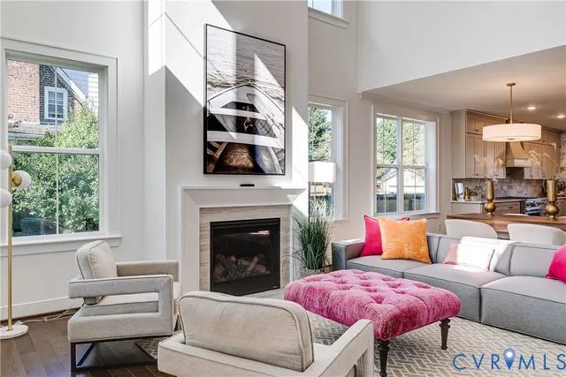 a living room with furniture and a chandelier