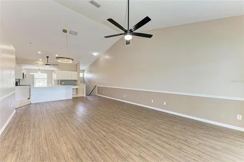 a large kitchen with kitchen island a sink a center island stainless steel appliances and a counter top space