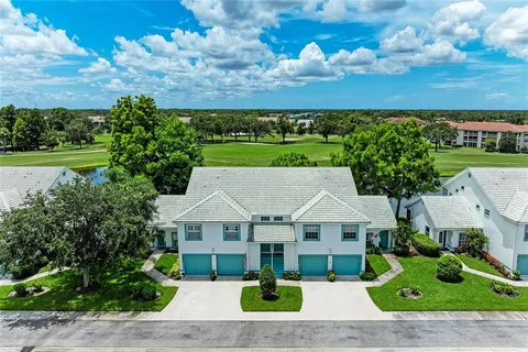 a front view of a house with a yard and a garage