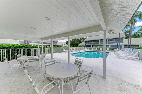 a view of a swimming pool with a patio and a yard