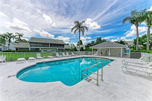a view of a swimming pool with a lounge chairs