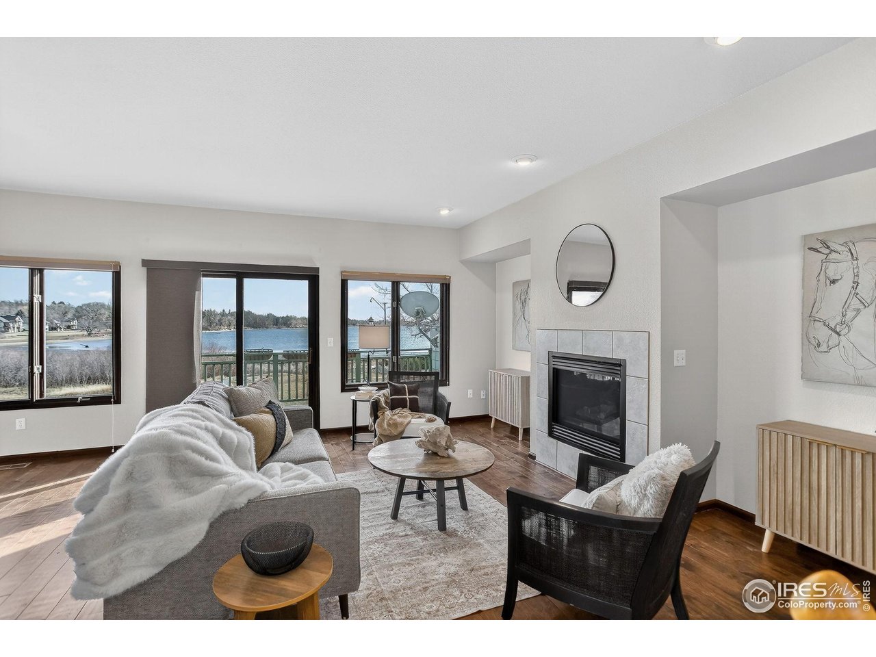 3658 Point Drive Fort Collins, CO 80524 - Photo 12 of 50 a living room with furniture a fireplace and a large window