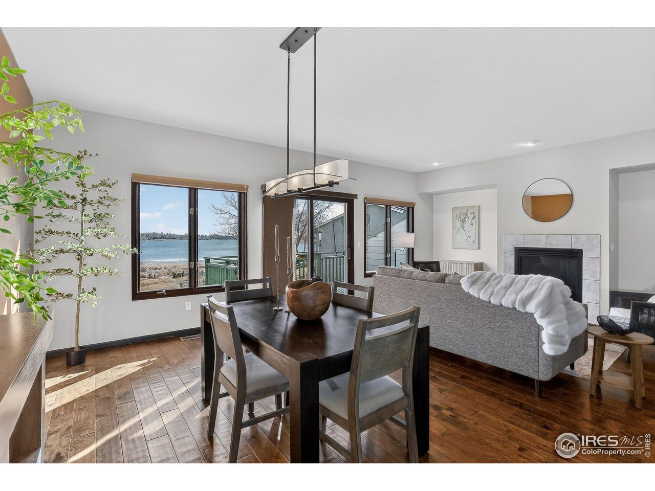 3658 Point Drive Fort Collins, CO 80524 - Photo 15 of 50 a living room with furniture a window and a chandelier