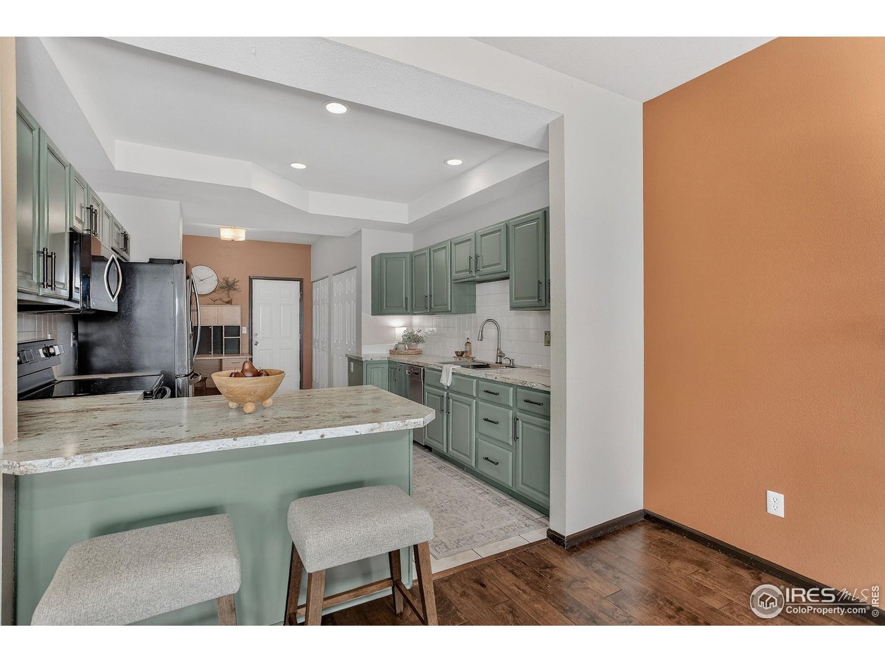 3658 Point Drive Fort Collins, CO 80524 - Photo 18 of 50 a kitchen with stainless steel appliances kitchen island granite countertop a sink and cabinets