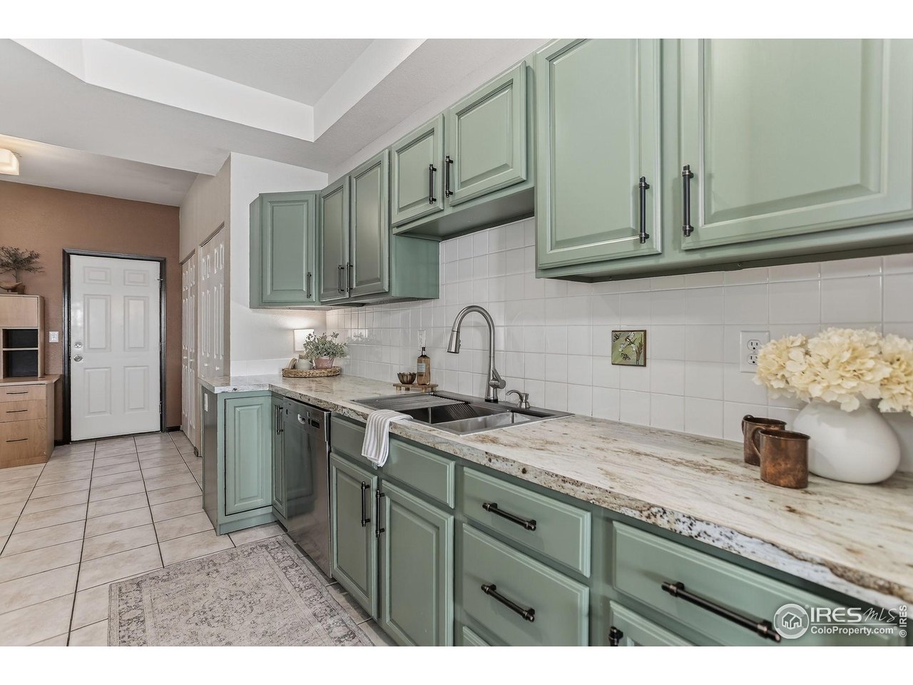 3658 Point Drive Fort Collins, CO 80524 - Photo 19 of 50 a kitchen with stainless steel appliances granite countertop a sink a stove and cabinets