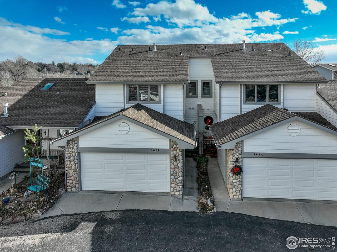 3658 Point Drive Fort Collins, CO 80524 - Photo 2 of 50 a front view of a house with a yard and garage