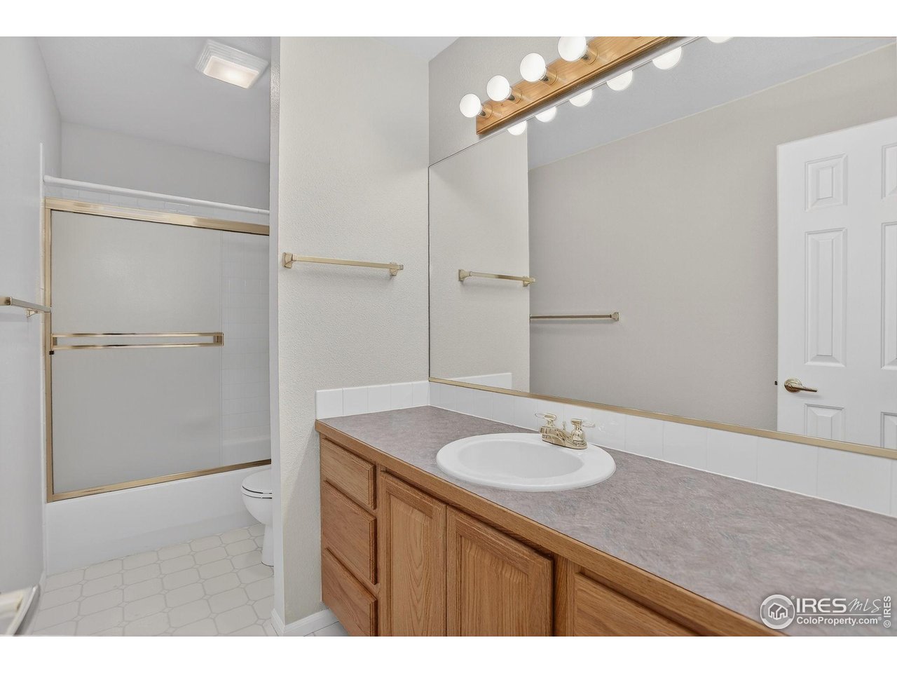 3658 Point Drive Fort Collins, CO 80524 - Photo 36 of 50 a bathroom with a sink vanity granite and a mirror