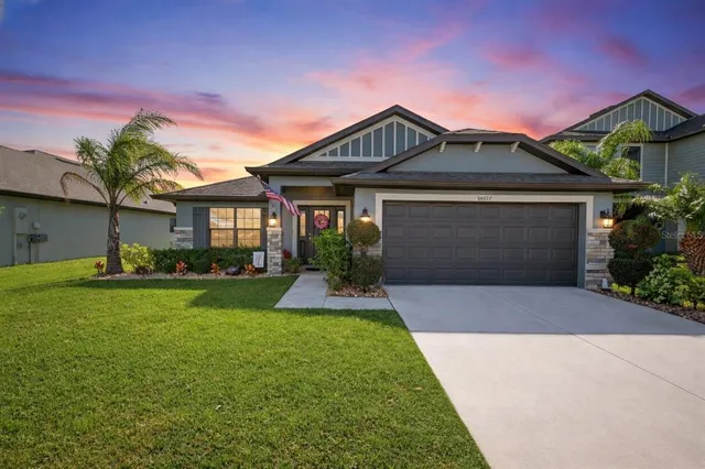 a front view of a house with a yard and garage