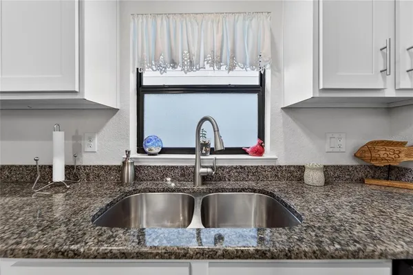 a living room with furniture a rug and a flat screen tv