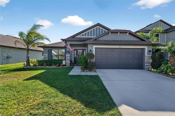 a front view of a house with a yard and garage