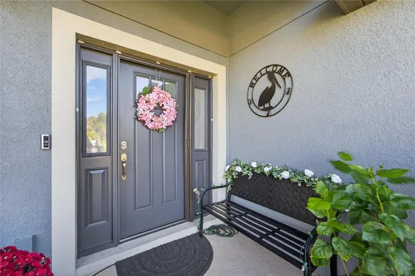 a dining room with furniture and a potted plant