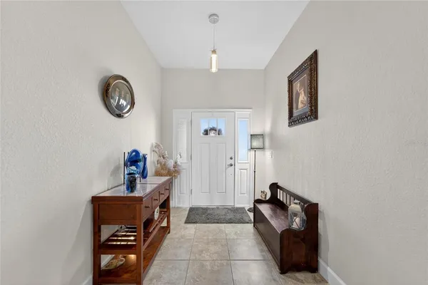 a view of a dining room with furniture and chandelier