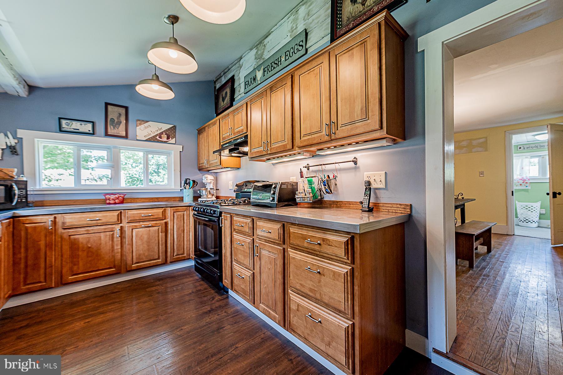 77 Love Run Road Colora, MD 21917 - Photo 18 of 43 a kitchen with stainless steel appliances granite countertop wooden cabinets a sink a stove a refrigerator and dishwasher with wooden floor