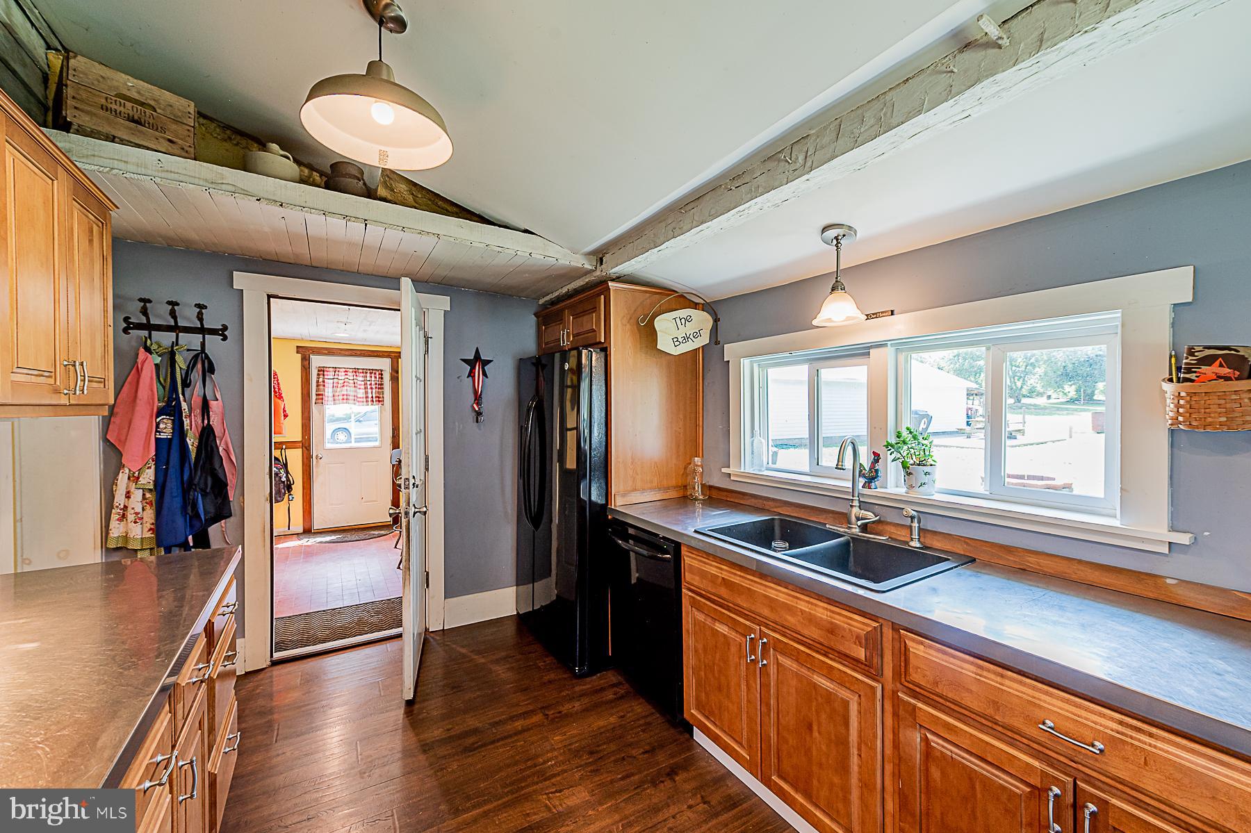 77 Love Run Road Colora, MD 21917 - Photo 20 of 43 a kitchen with stainless steel appliances granite countertop a sink and wooden floors