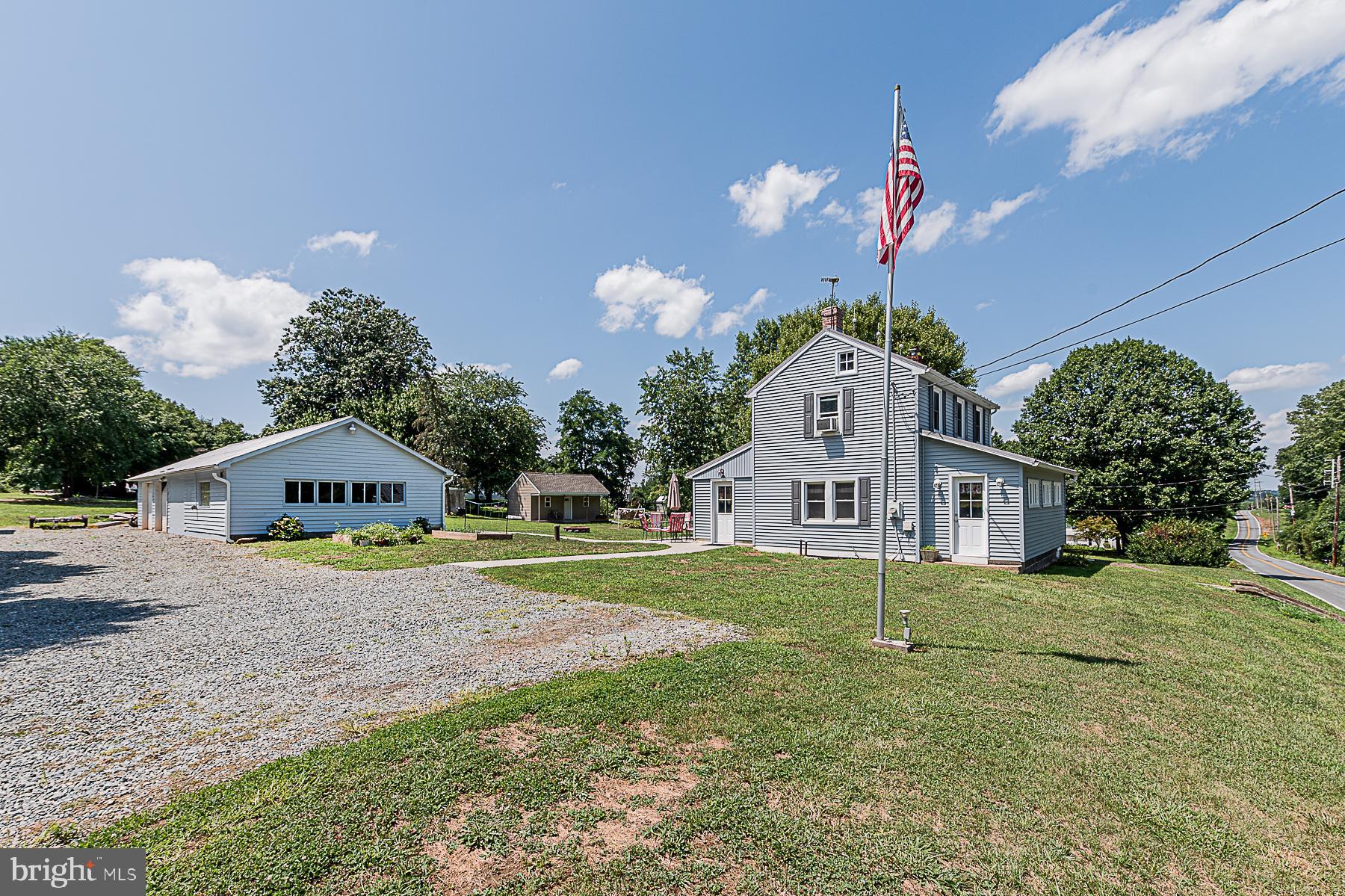 77 Love Run Road Colora, MD 21917 - Photo 4 of 43 a front view of a house with a yard and garage