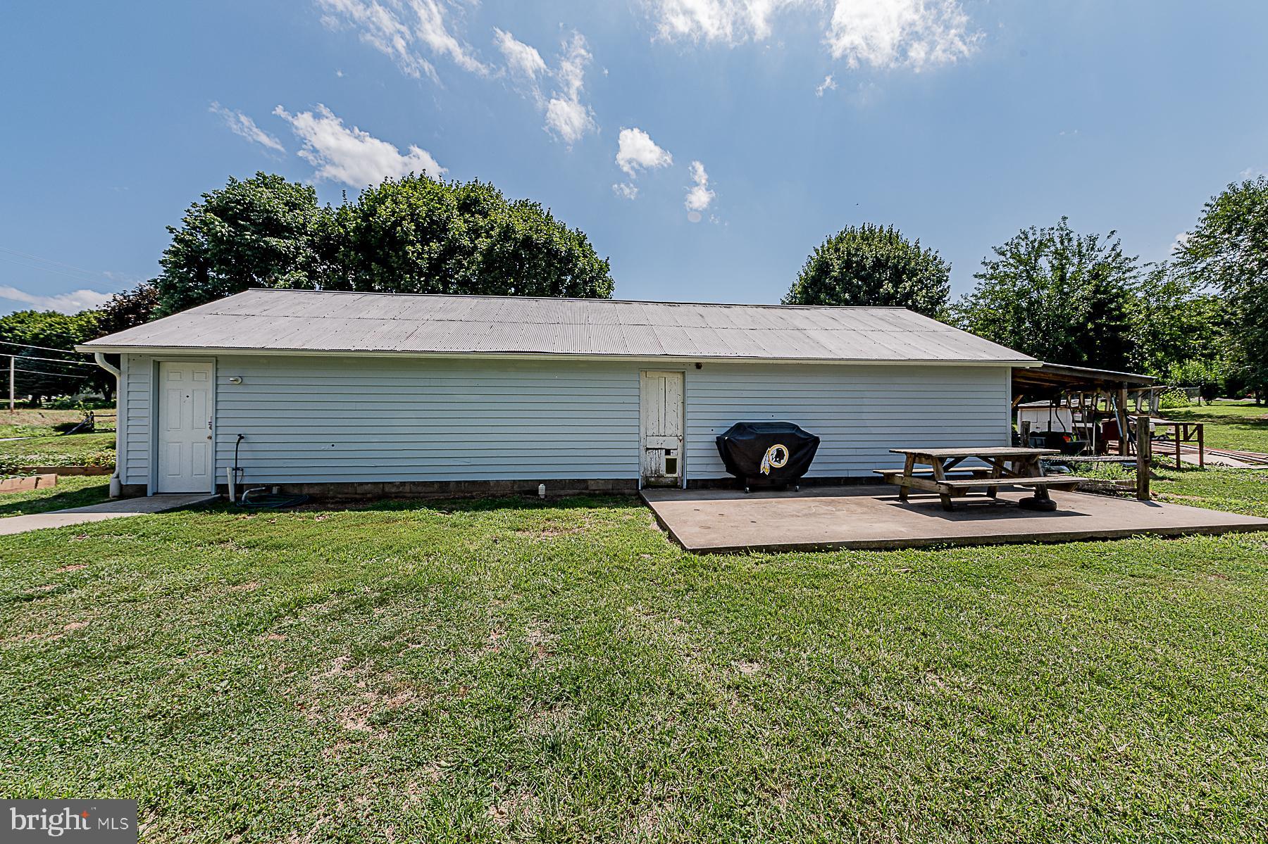 77 Love Run Road Colora, MD 21917 - Photo 10 of 43 a view of a backyard with table and chairs under an umbrella