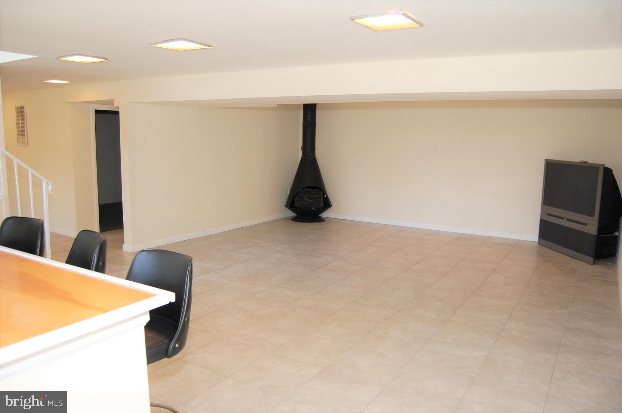 818 Hopewood Road Pikesville, MD 21208 - Photo 9 of 24 Finished Lower Level w/Fireplace/Stove