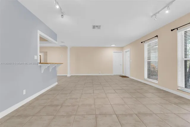 a view of an empty room with a window