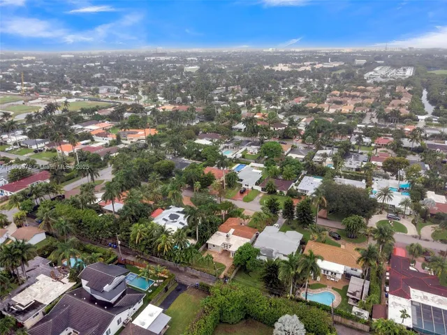 an aerial view of residential houses with city view
