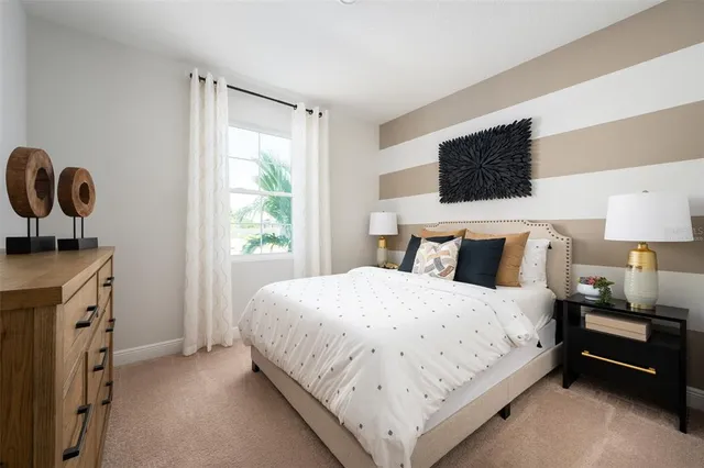 a bedroom with bed cabinet and window