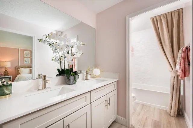 a bathroom with a sink a mirror and vanity