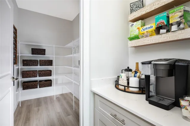 a view of a workspace with furniture and wooden floor
