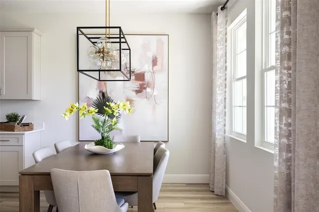 a dining room with furniture and wooden floor
