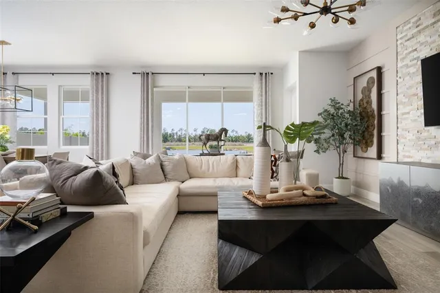 a living room with furniture and a large window