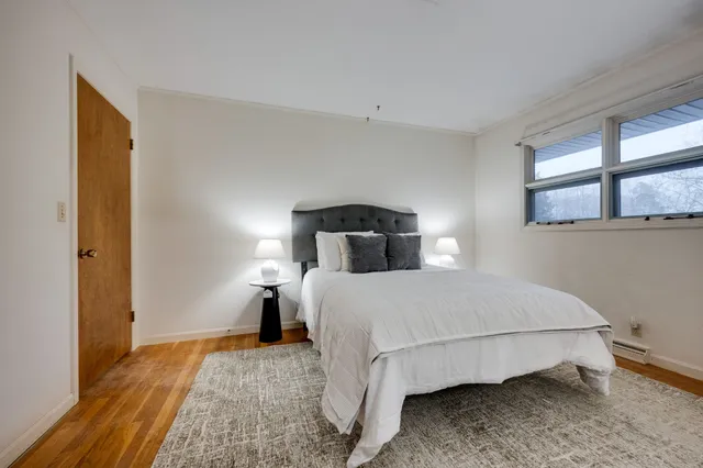 a bedroom with a bed and window