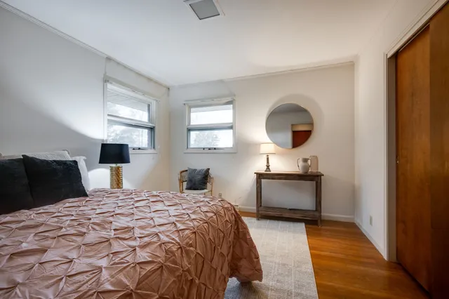 a bedroom with a bed and a potted plant
