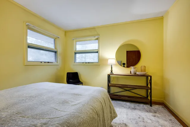 a bedroom with a bed and a window