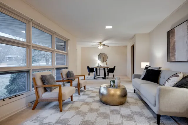 a living room with furniture and a large window