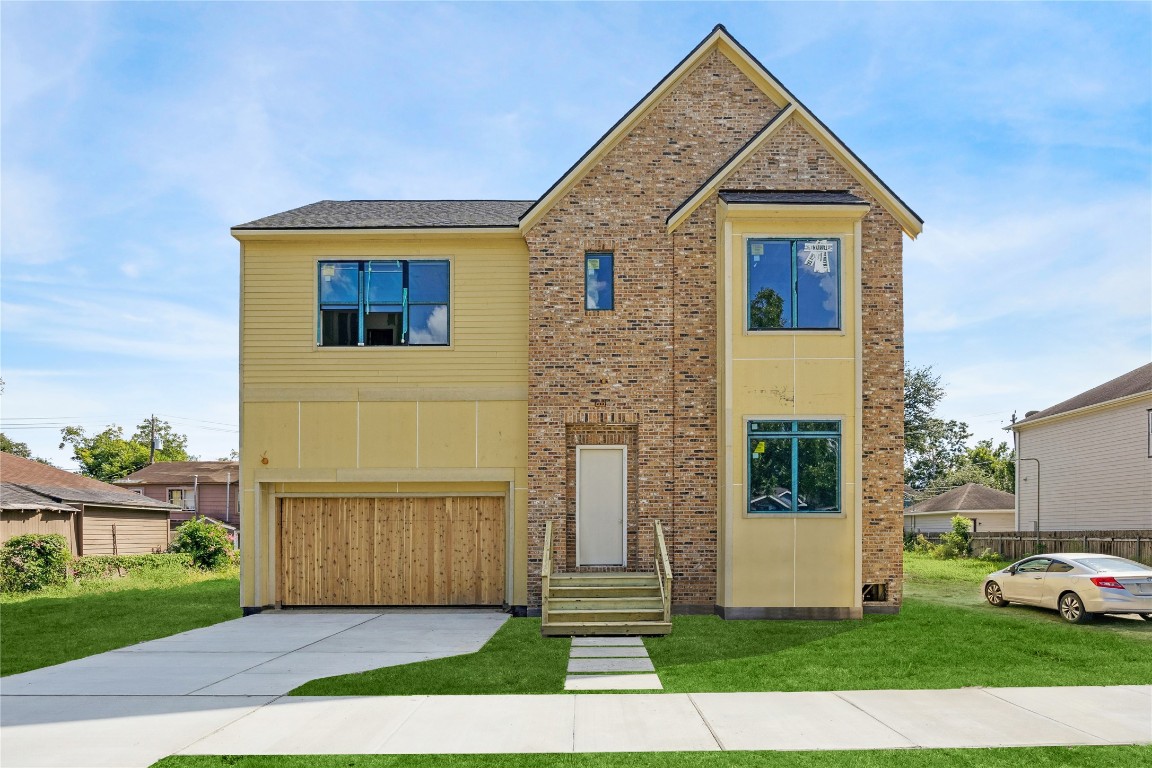 a front view of a house with a yard