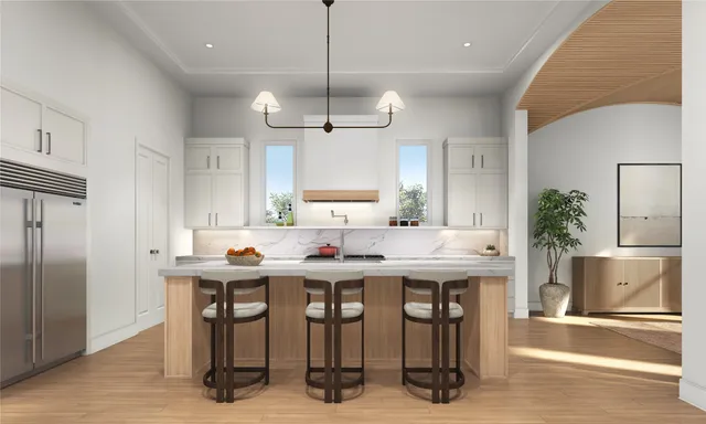 a kitchen with stainless steel appliances kitchen island a table chairs in it and wooden floors