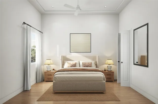 a bedroom with a large bed and a potted plant