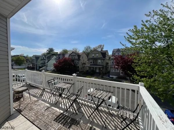 a view of balcony with wooden floor and outdoor seating