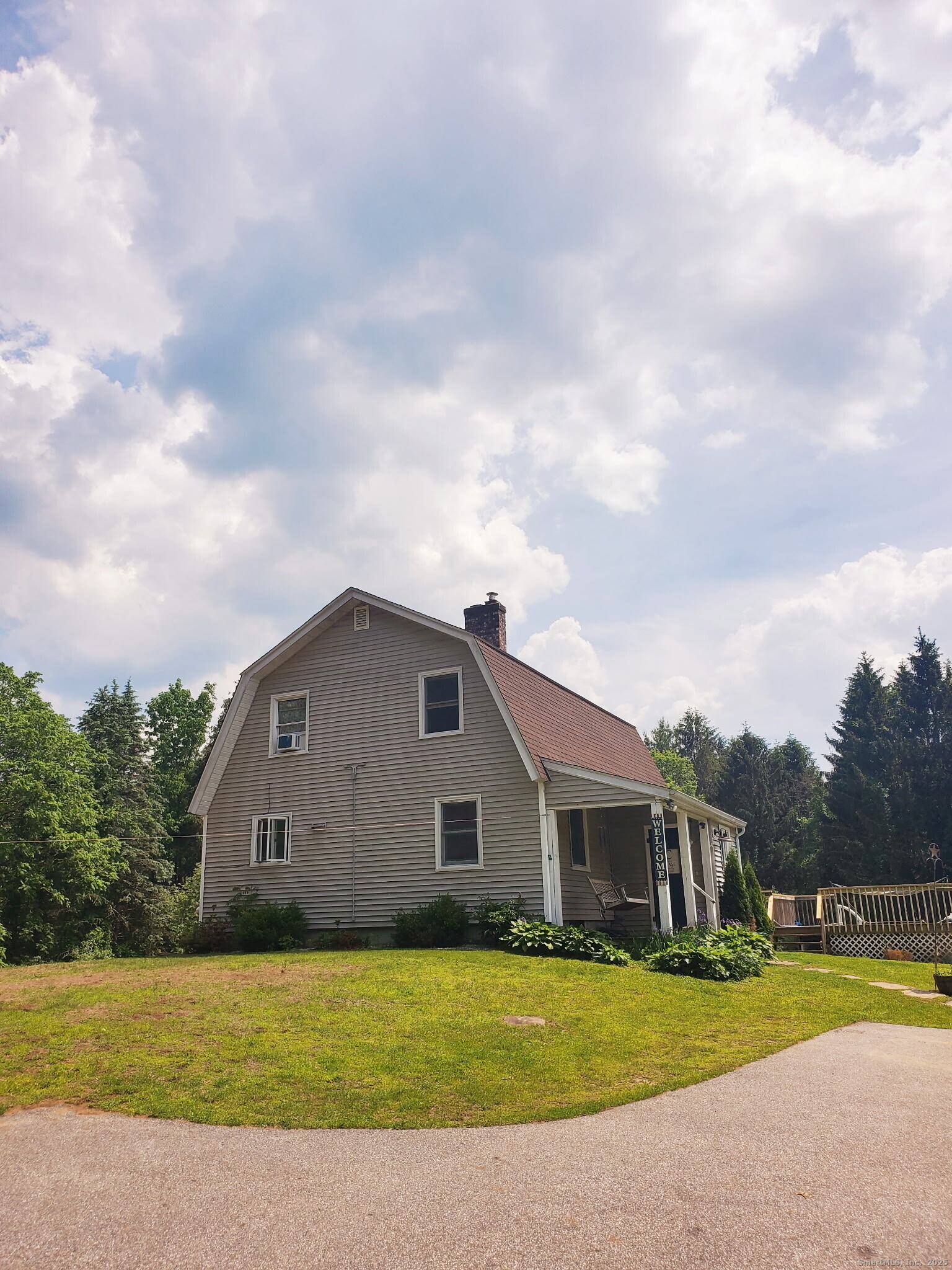 a view of a house with garden and a yard