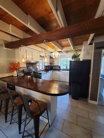 a living room with stainless steel appliances kitchen island granite countertop furniture and a kitchen view